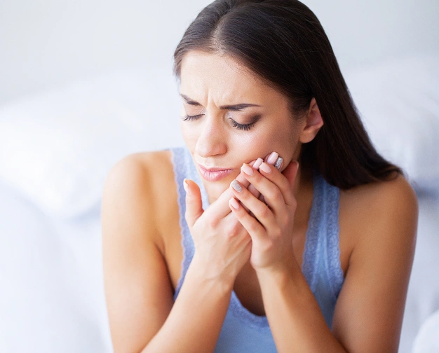 a girl suffering tooth pain