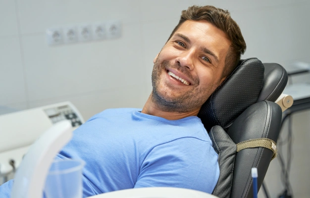 a young man seating a dentist chair