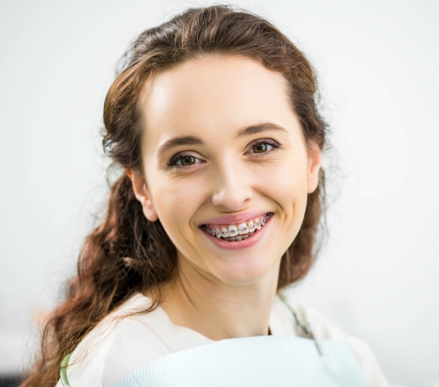 a young girl smiling after attached traditional braces in Culver City CA